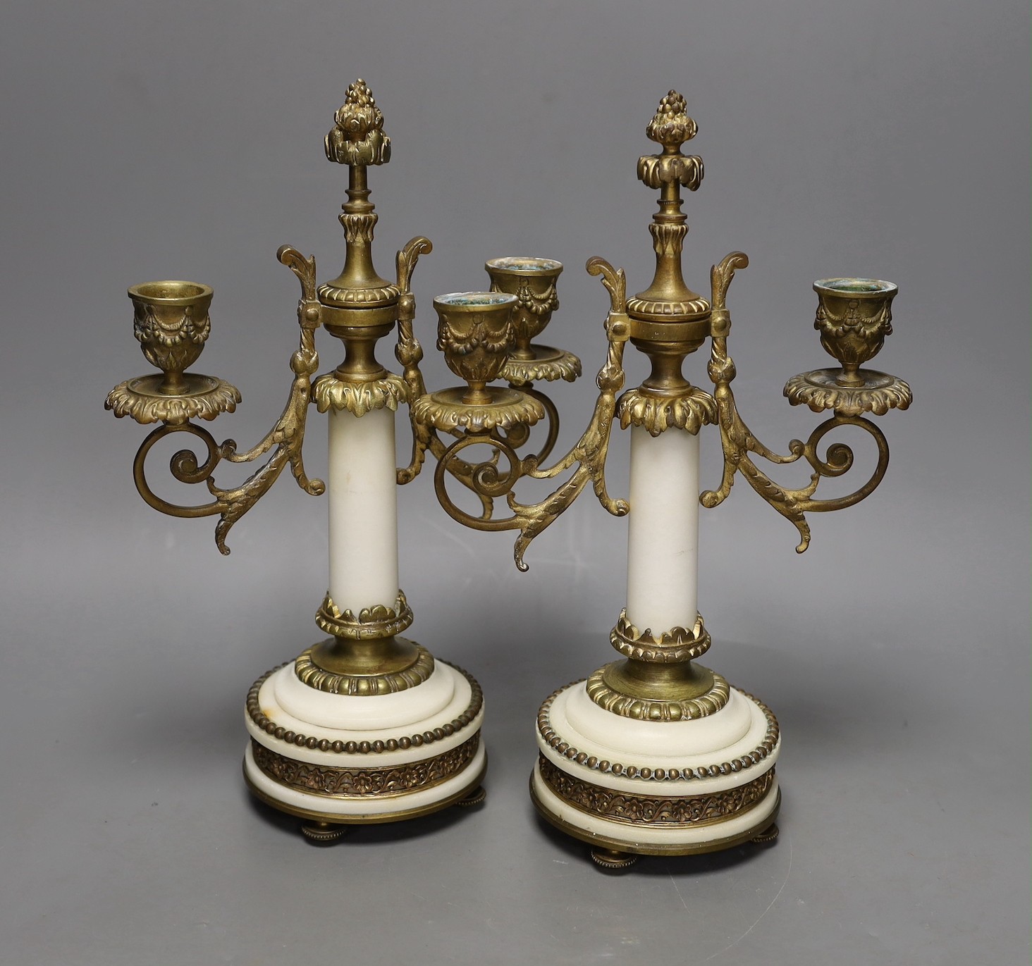 A pair of gilt bronze and marble two branch candelabra, 30cms high